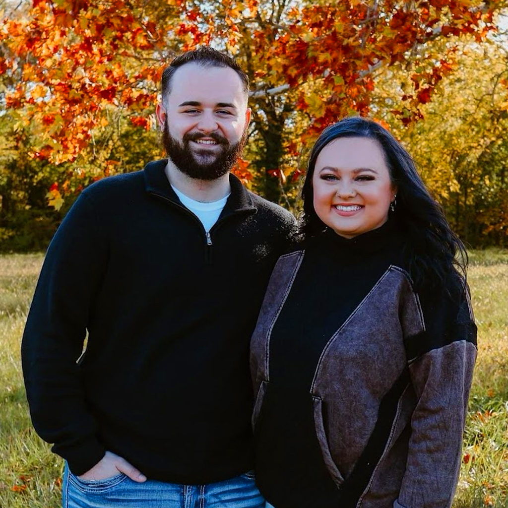 Ridgeline Roofing and Solar's General Manager, Jordan Lee and Wife posing for a photo with a background of trees with the leaves changing colors.